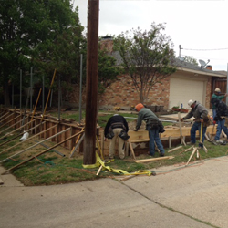 Retaining Wall Dallas TX Workers constructing a retaining wall at a home.