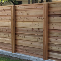 Retaining Wall Dallas TX A wood fence installed with cement supports.