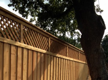 A wood fence in a residential yad.